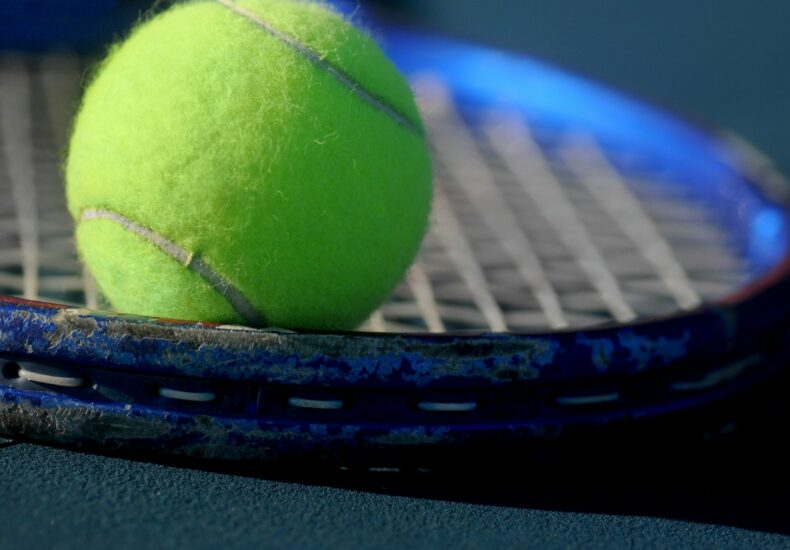 green tennis ball in closeup photography